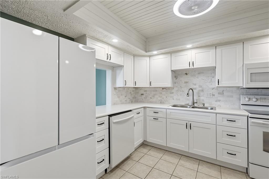 Updated kitchen features sleek appliances, all new soft-close cabinets with multiple drawers and pass through to dining.