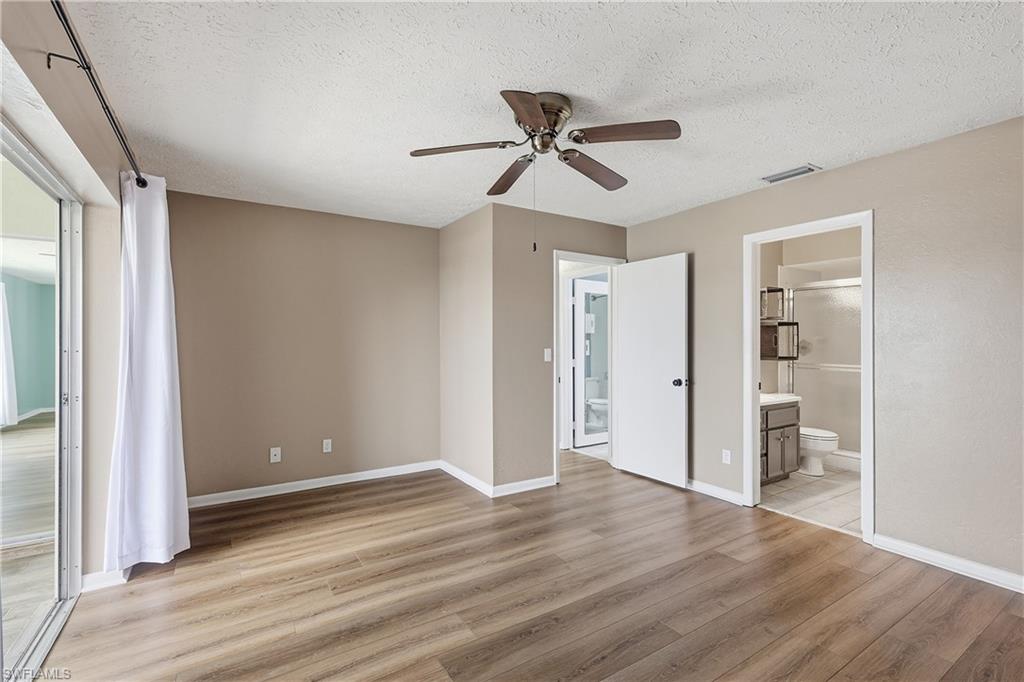 Spacious primary bedroom has an ensuite bathroom and walk-in closet. Luxury vinyl flooring and tile throughout entire unit. Linen closet is in hallway.
