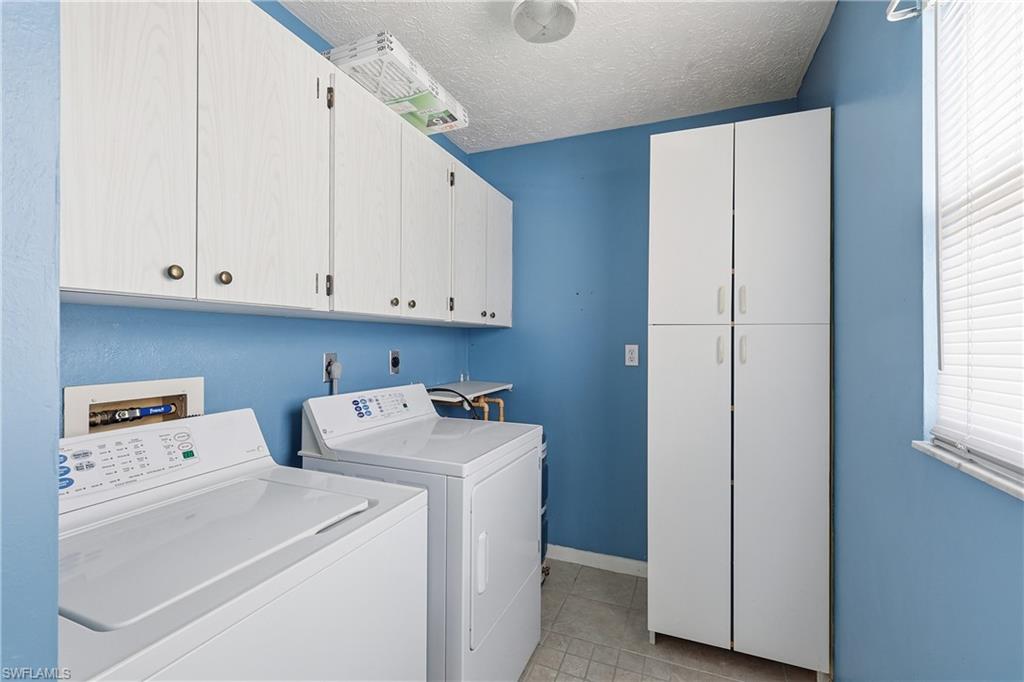 Full size washer & dryer and lots of storage cabinets are located in this laundry room near the front door.