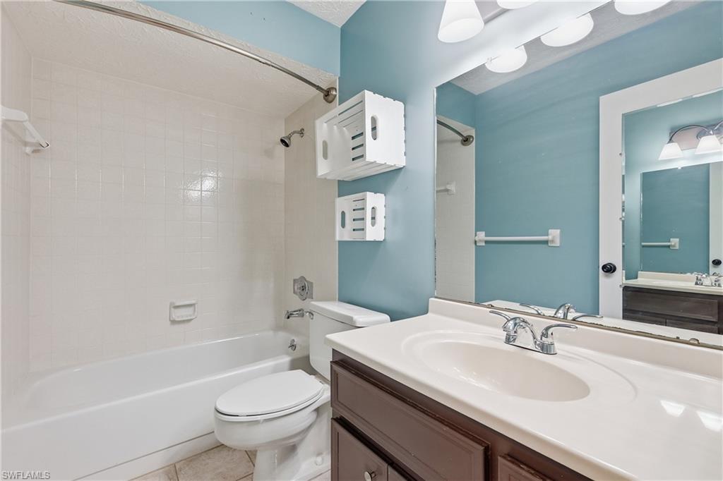 Guest bathroom with tiled shower/tub combo is between the 2 bedrooms.