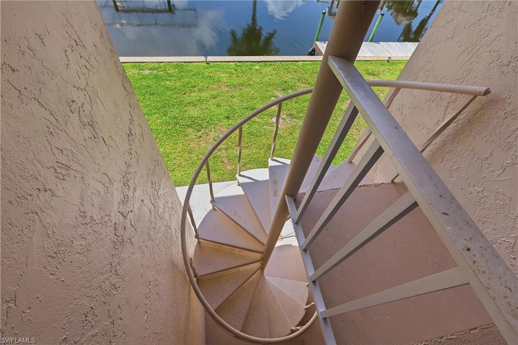 Stairway out the backdoor of the lanai allows easy access to boat dock and pool.