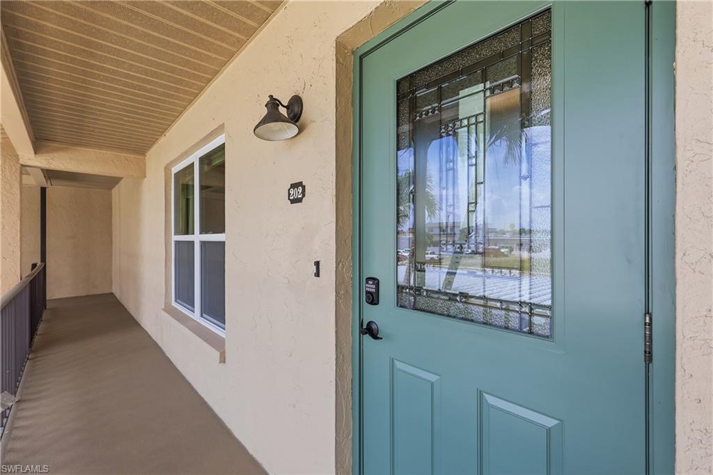 Beautiful NEW front door with impact resistant glass for each unit! Guest bedroom windows shown are also new and impact resistant.