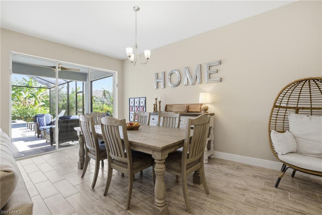 Dining area with wood-finish flooring and neutral wall tones