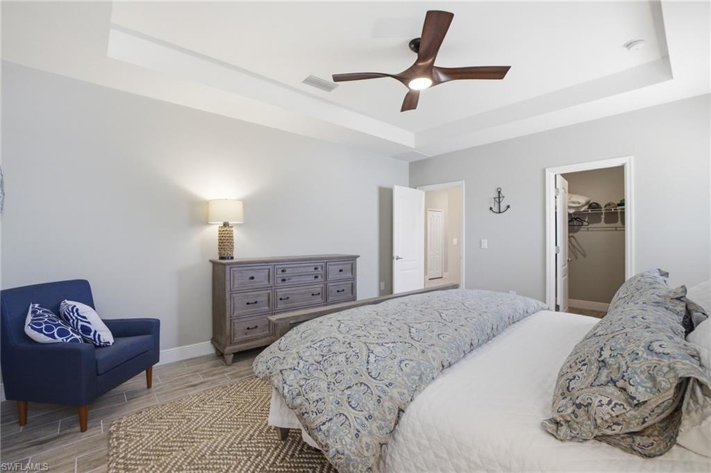 Recessed ceiling with a modern ceiling fan and recessed lighting