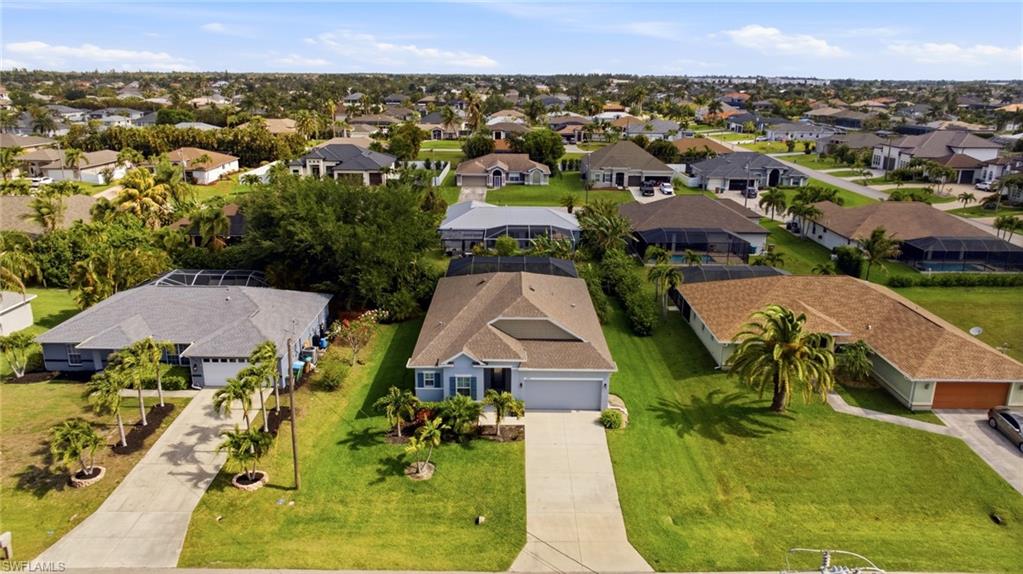 Residential neighborhood featuring single-story homes with shingle roofs and screened lanais