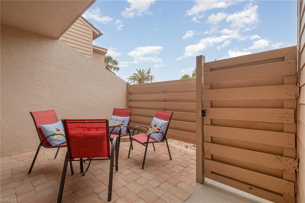 View of patio featuring fence and outdoor dining space