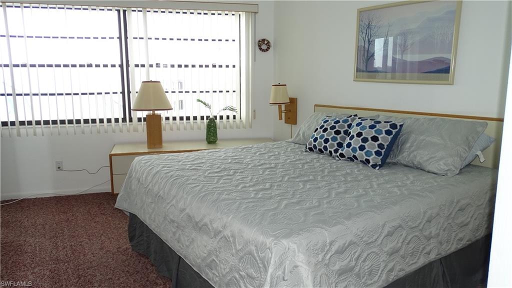 Bedroom with textured wall-to-wall carpeting