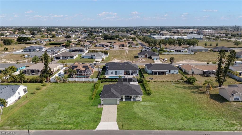 Aerial perspective of a residential neighborhood with a clear sky backdrop