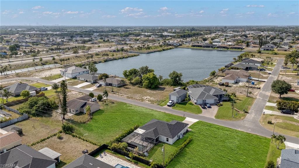 Aerial view of a residential area featuring a prominent lake