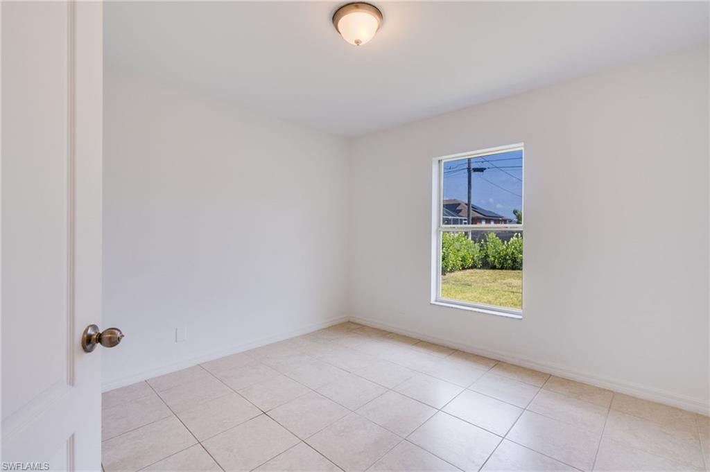 Light-filled room featuring neutral wall finishes and large format tile flooring