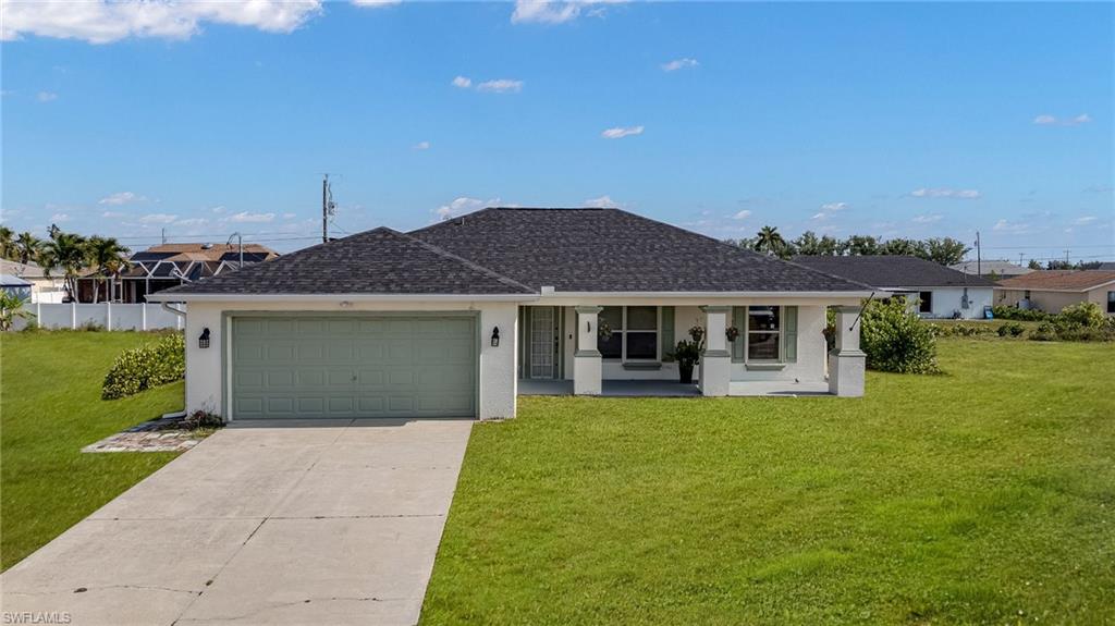 Contemporary single-story residence featuring a dark shingle roof and a light-colored exterior finish