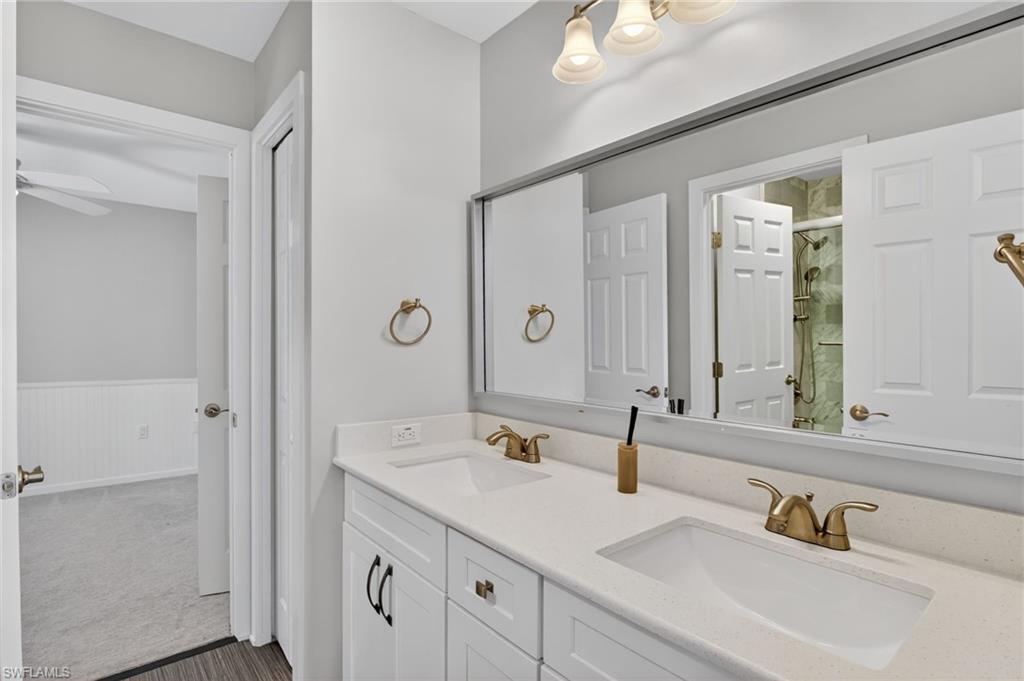 Double vanity with integrated sinks, quartz countertop, and brushed nickel hardware
