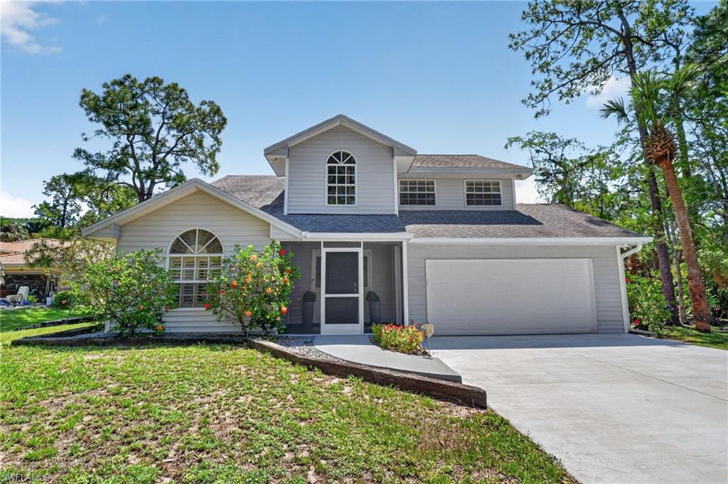 Two-story residence featuring light gray siding and a gray shingle roof