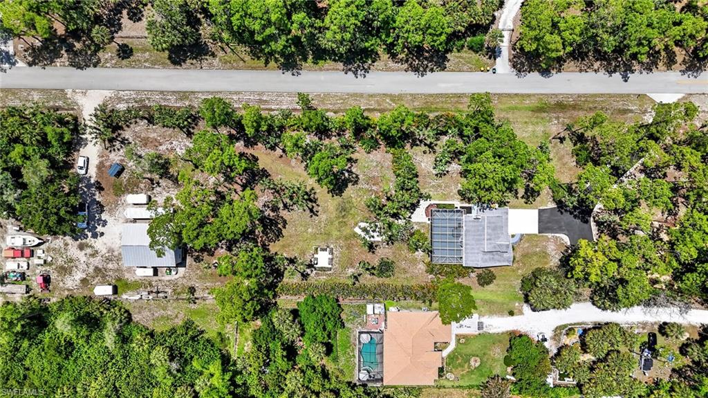 Expansive property featuring mature trees and two distinct structures