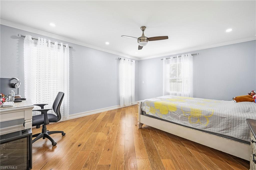Room featuring wood-finish flooring, recessed lighting, and a ceiling fan