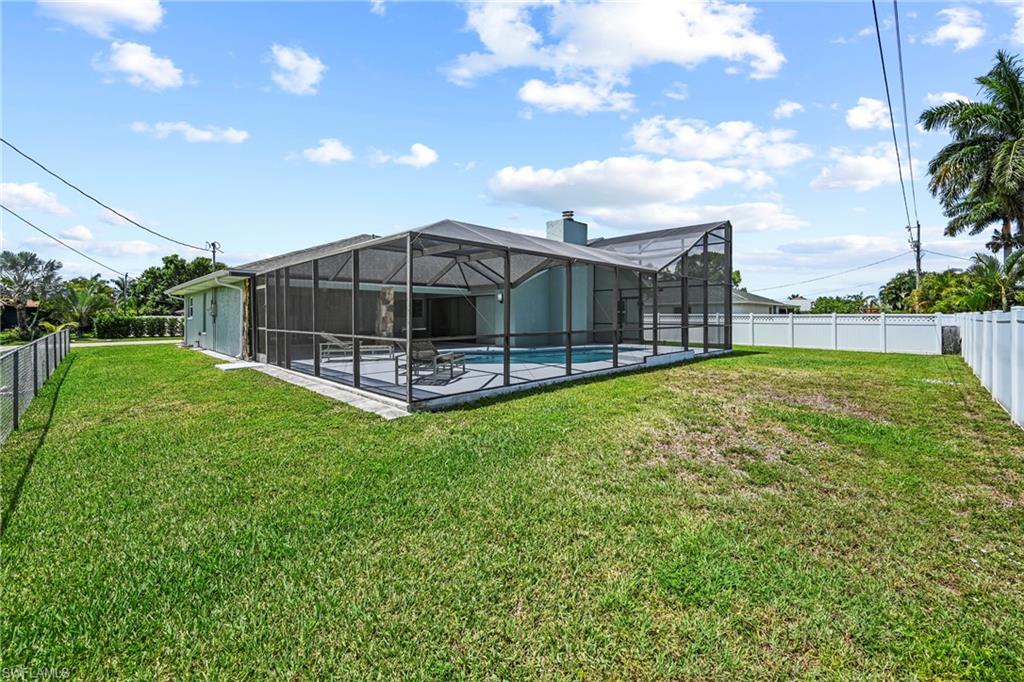 Spacious backyard with a screened pool enclosure and concrete pool deck