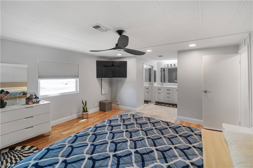 Bedroom featuring wood-finish flooring, a ceiling fan, and recessed lighting
