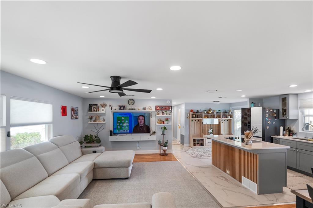 Open-concept living space featuring recessed lighting, a ceiling fan, and hardwood flooring