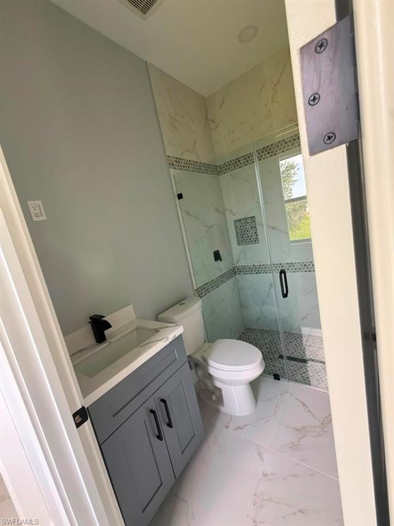 Spacious room featuring large format tile flooring, a black-framed glass-paneled exterior door, a white interior door, and recessed lighting