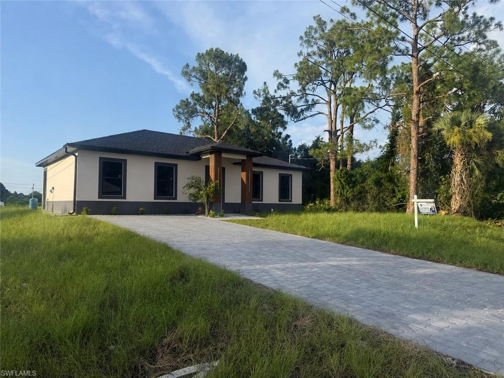 Contemporary residence featuring a light-toned exterior with dark trim accents