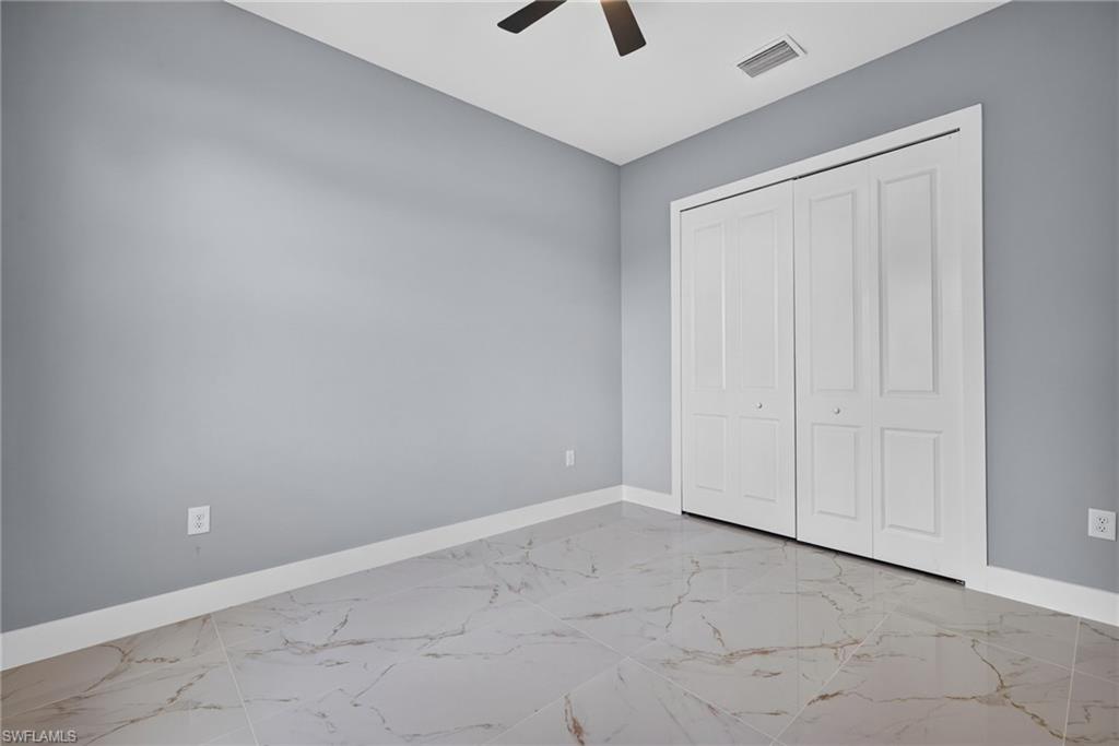 Light gray walls complemented by white baseboards and white paneled bi-fold closet doors