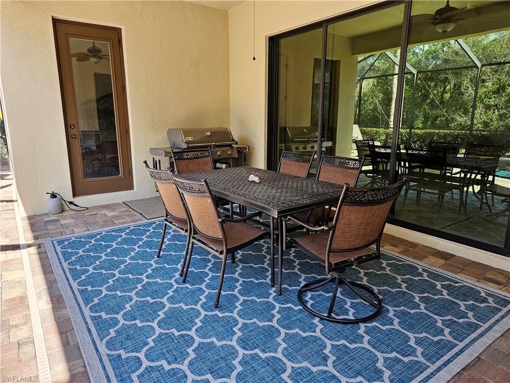 View of patio with area for grilling, outdoor dining area, and exterior kitchen
