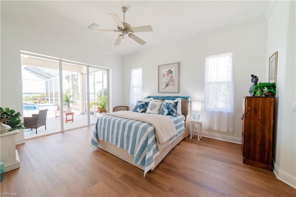 Spacious Primary Bedroom with view of pool area and bay
