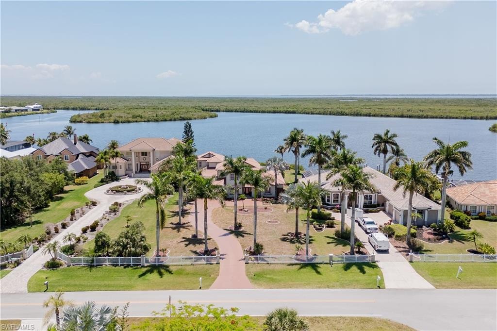 Waterfront property featuring extensive water frontage, mature palm trees,