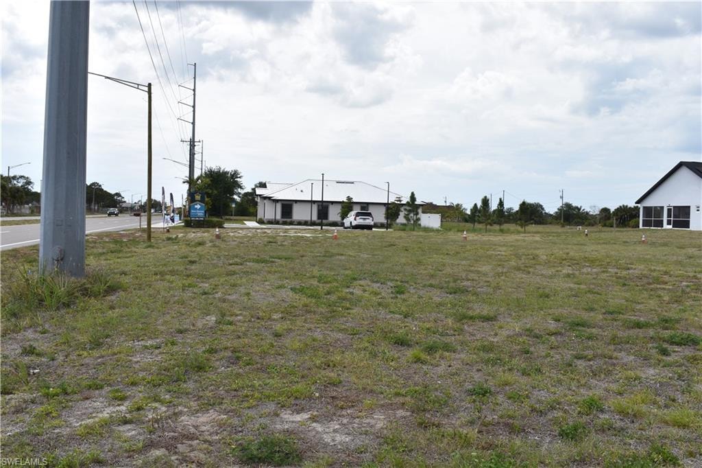 Expansive undeveloped lot featuring a sparse grass ground cover, offering a generous footprint
