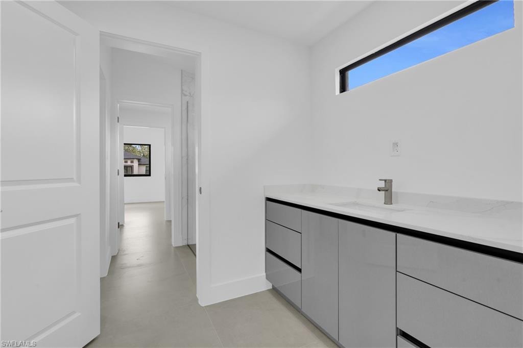 Bathroom featuring vanity and finished concrete flooring
