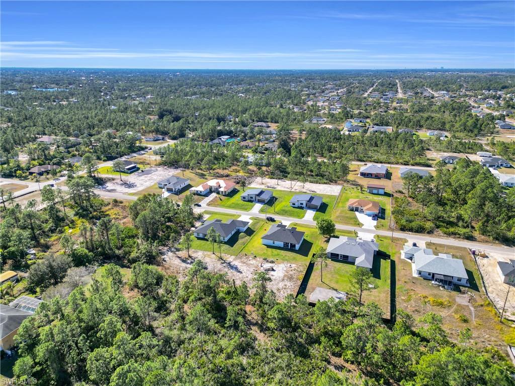 Aerial view of property's location featuring nearby suburban area