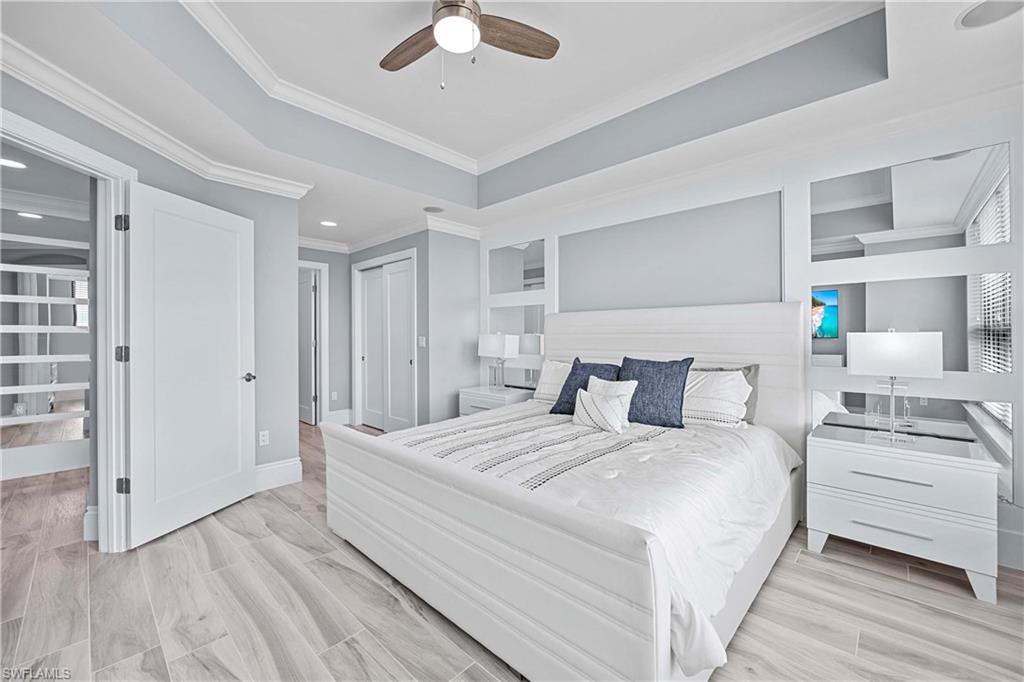 Bedroom featuring crown molding, light hardwood / wood-style flooring, and ceiling fan