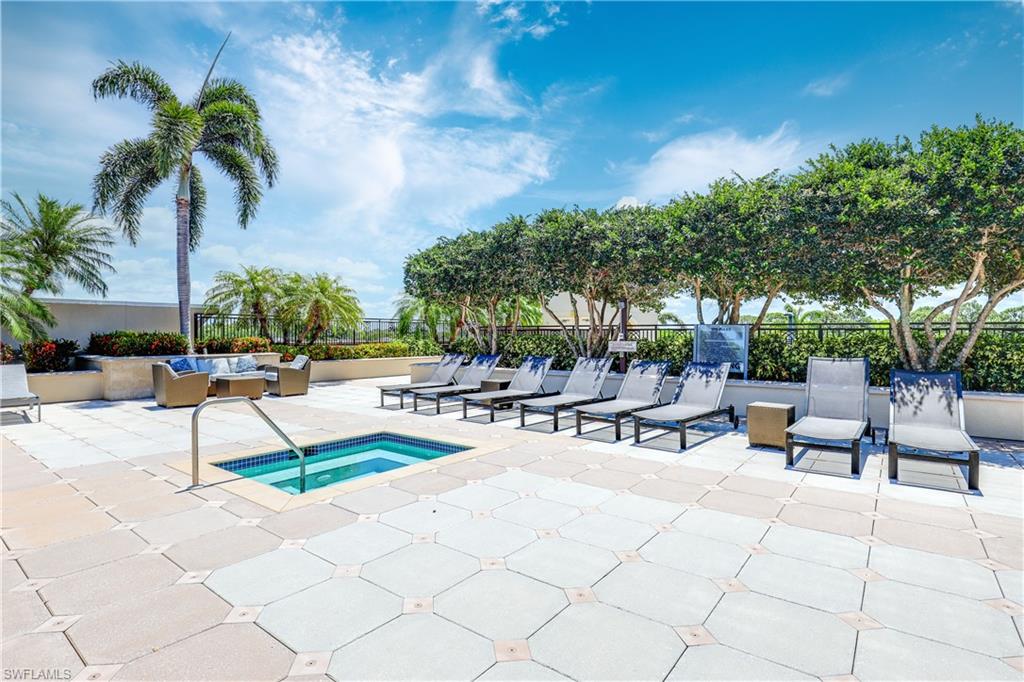 View of pool featuring a community hot tub and a patio