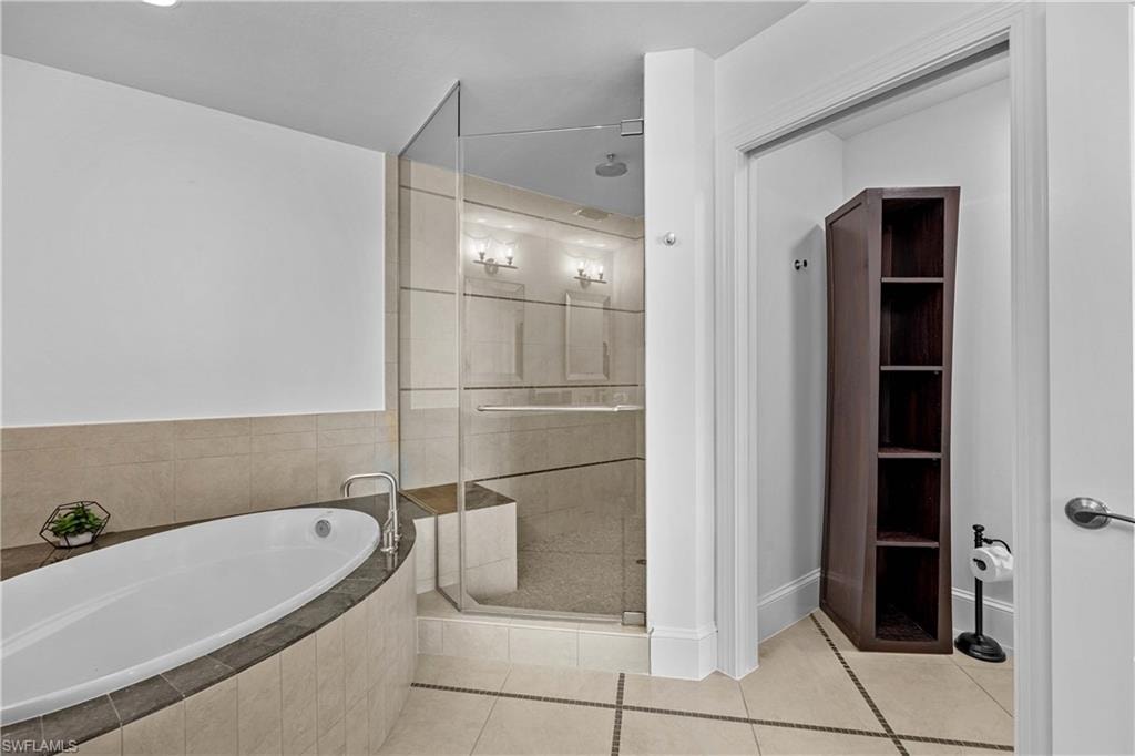 Bathroom featuring plus walk in shower and tile patterned flooring