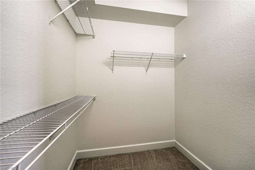One of two walk-in closets in hallway to primary bath