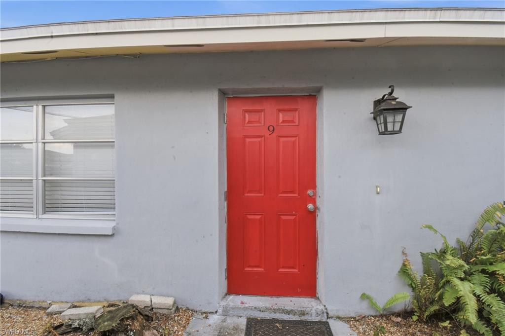 Red paneled entry door with silver hardware