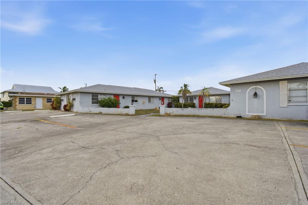 Multi-unit residential complex featuring stucco exteriors and shingle roofing