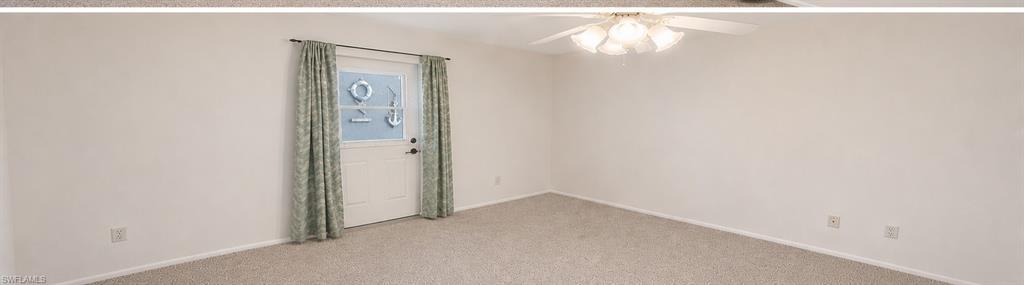 Light-toned wall-to-wall carpeting and neutral wall tones define this expansive interior space
