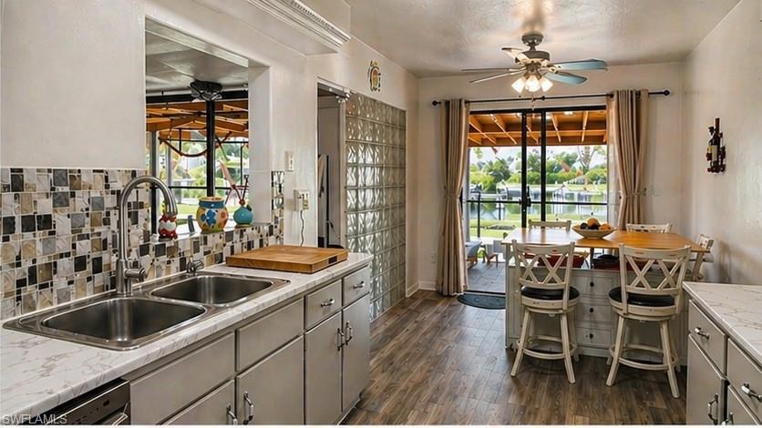 Kitchen featuring wood-finish flooring and a tiled backsplash