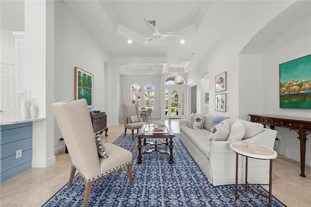 Living room with soaring ceilings and new fan.