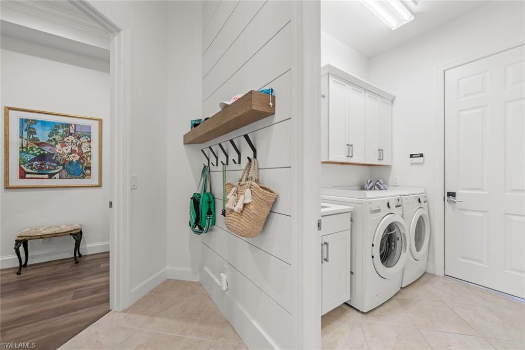 Laundry room with washer, dryer, sink and storage cabinets