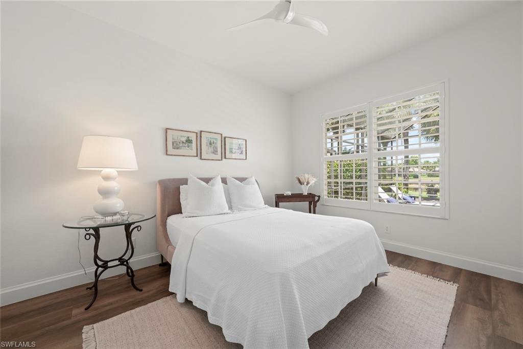 Guest bedroom with new vinyl flooring, new fan and plantation shutters.