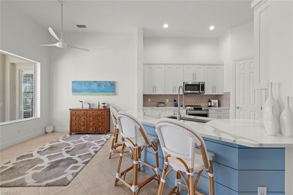 Renovated Kitchen with Quartz countertops and white kitchen cabinets.