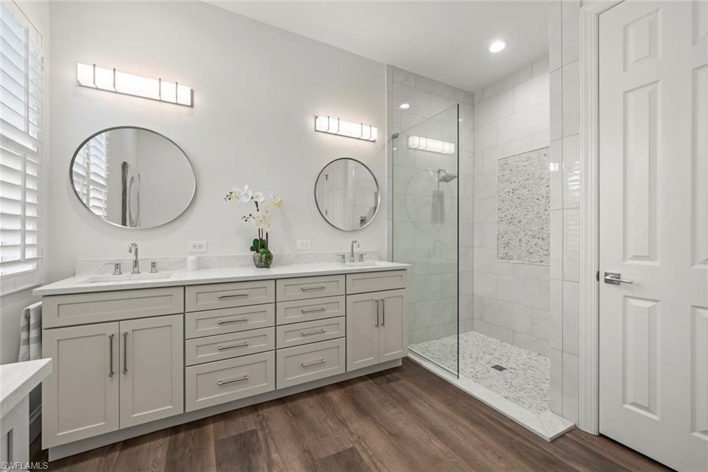 Renovated bathroom with new cabinets, quartz countertops, walk-in shower.