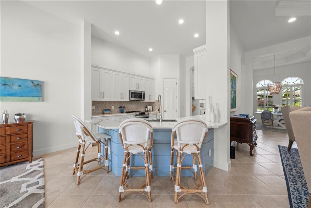 Renovated Kitchen with Quartz countertops, white kitchen cabinets and stainless steel appliances.
