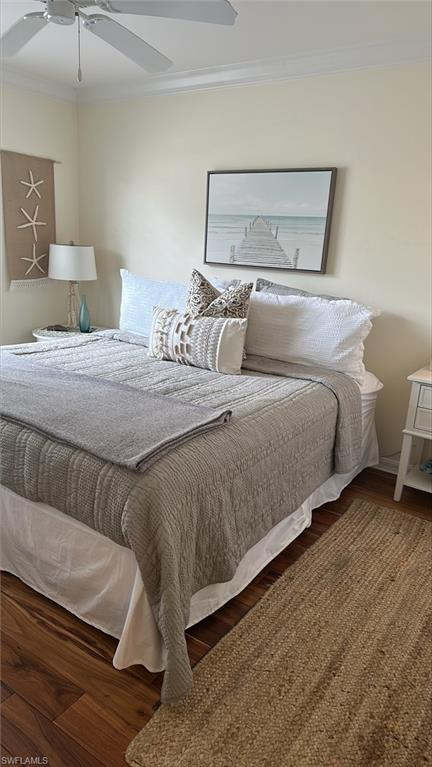 Master bedroom with King size bed, molding, ceiling fan, and wood finished floors
