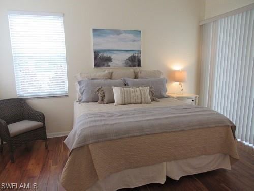 Master Bedroom, baseboards, wood finished floors & sliding door out to enclosed patio/lanai