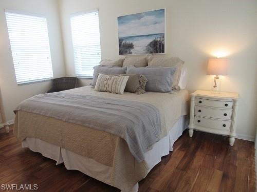 Bedroom with dark wood-type flooring