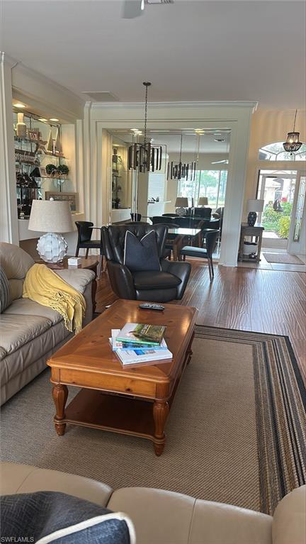 Living & dining area with beautiful Laminate flooring, huge mirror, glass front door.