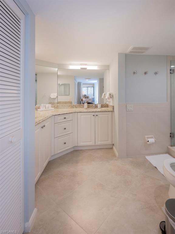 master bath area with a walk in closet and more